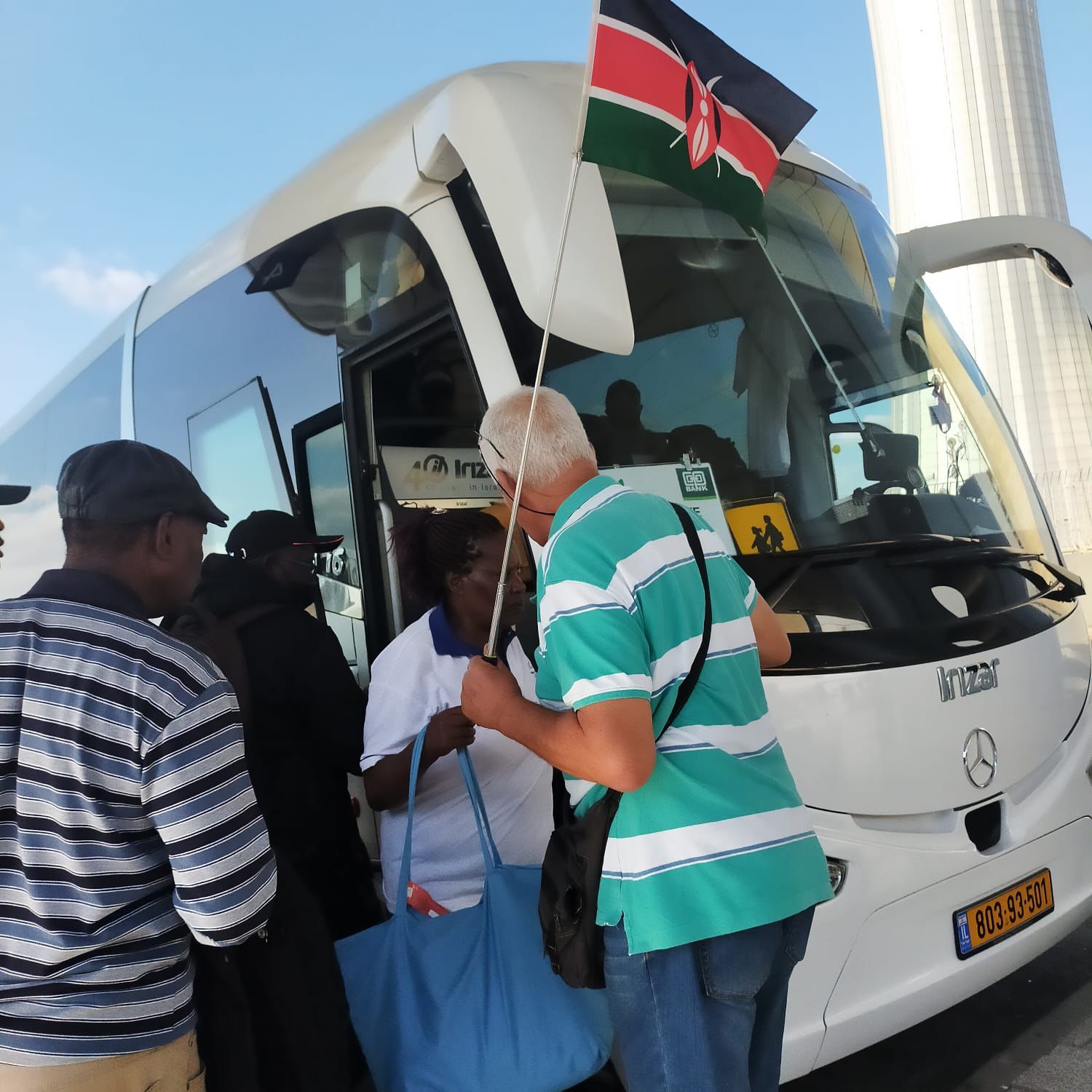 King David, a tour guide in Israel, assisting one of the MSME customers to board a bus upon arrival in Israel
